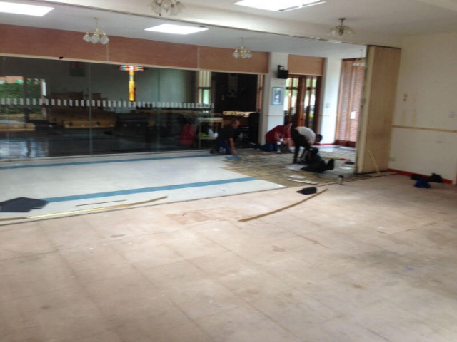 Commercial luxury vinyl tile being fitted at Trinity Church Cheadle