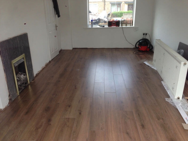 Advanced 8mm laminate millennium oak brown installed in a living room