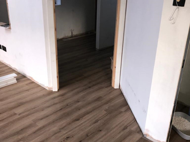 Polyflor Camaro Siena oak fitted to a kitchen and living room