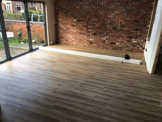 Polyflor Camaro Siena oak fitted to a kitchen and living room
